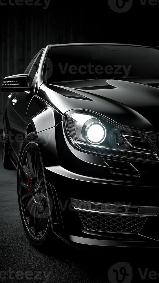 High-performance black luxury sedan showcased in a sleek studio setting at night with dramatic lighting and modern design elements photo