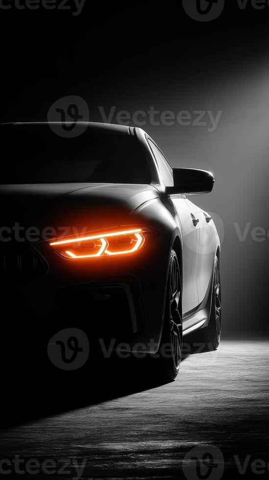 Luxury sports car in dramatic lighting showcasing sleek design features and glowing headlights in an artistic setting photo