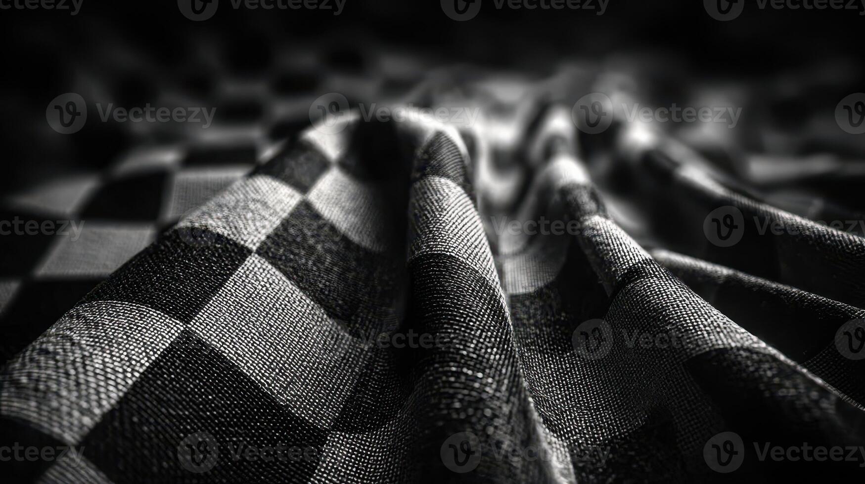 Textured black and white checkered fabric drapes elegantly on a flat surface in an artistic arrangement photo