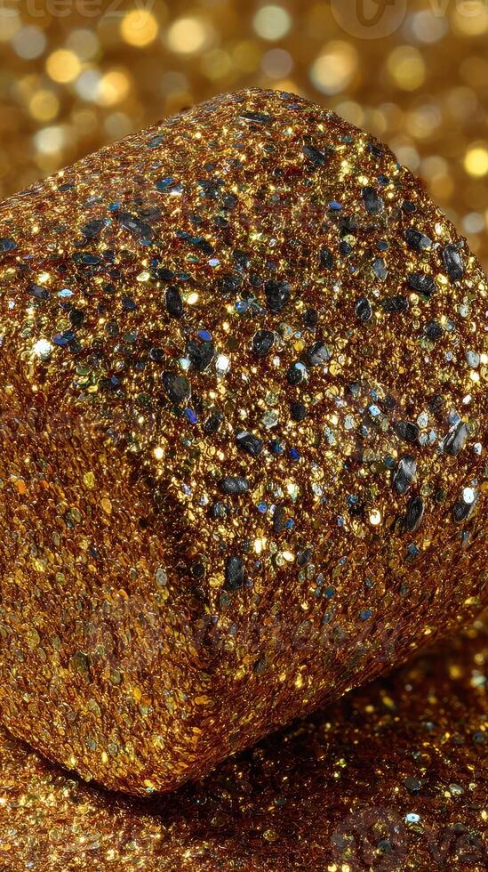 Shimmering golden glitter with vibrant sparkles in a close-up view perfect for art and craft projects photo
