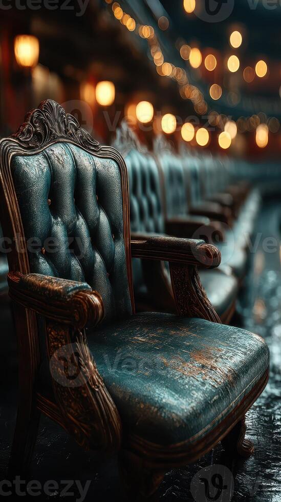 Elegant vintage chairs lined up in a dimly lit auditorium with warm glowing lights during an evening event photo