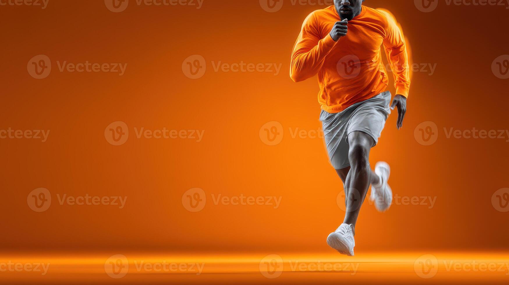 Athlete running in bright orange attire on a vibrant background during a training session photo