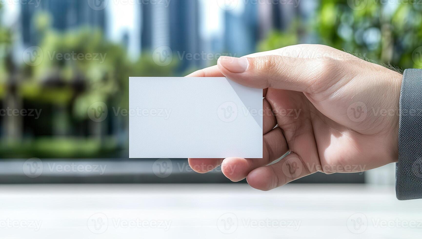 Hand Holding Blank Business Card in City photo