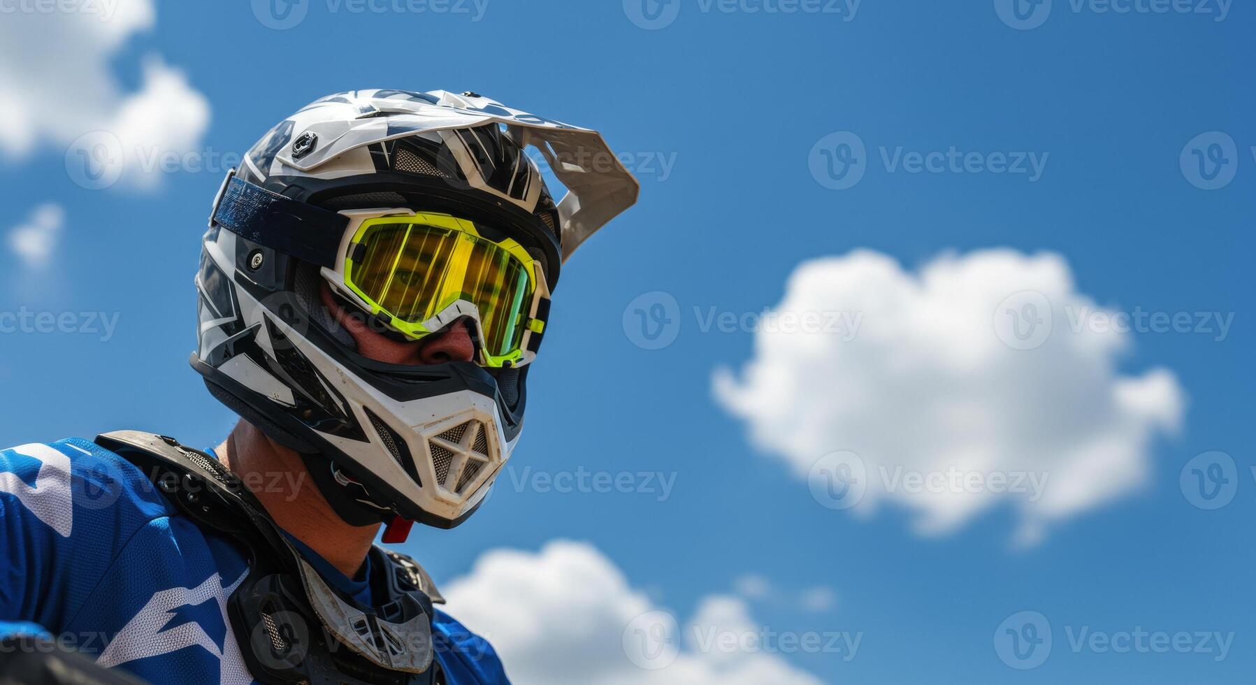 Close up low angle view of a motocross man wearing helmet and goggles photo