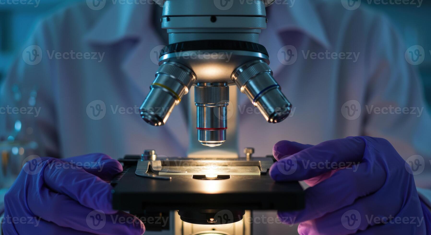 Scientist in purple gloves using a microscope in a laboratory photo