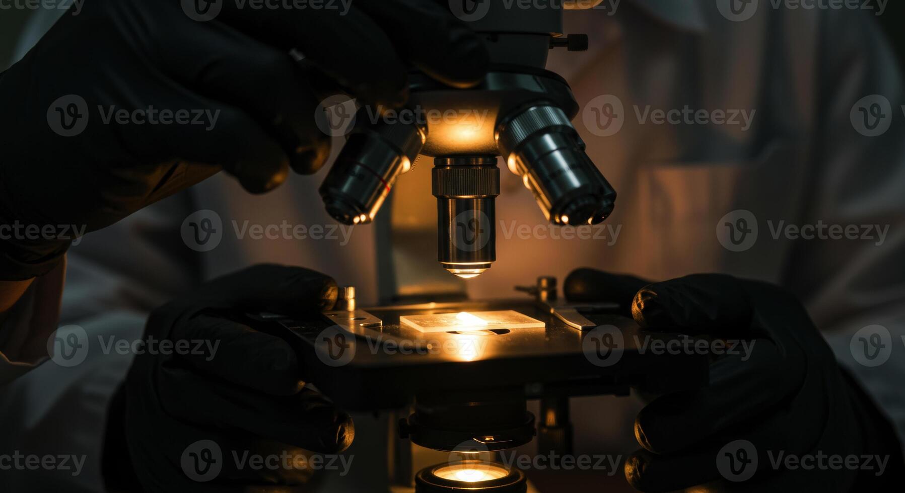 Close up of scientist hands using a vintage microscope in a dark laboratory photo