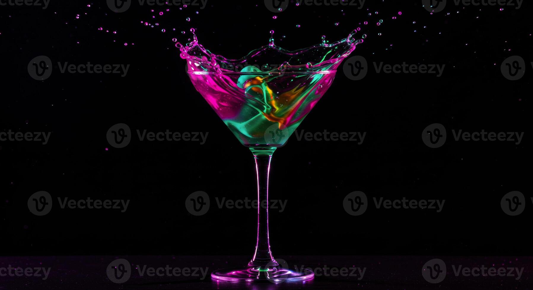 Dramatic studio shot of cocktail glass with dynamic colorful liquid splash photo