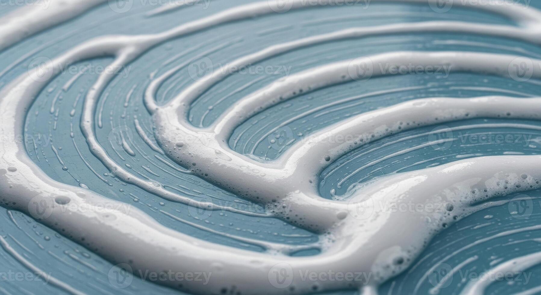 Close up macro shot of white cleaning foam on a textured light blue surface photo