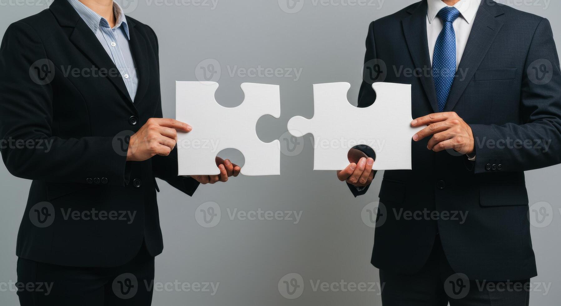 Business people connecting puzzle pieces symbolizing teamwork and finding a solution photo
