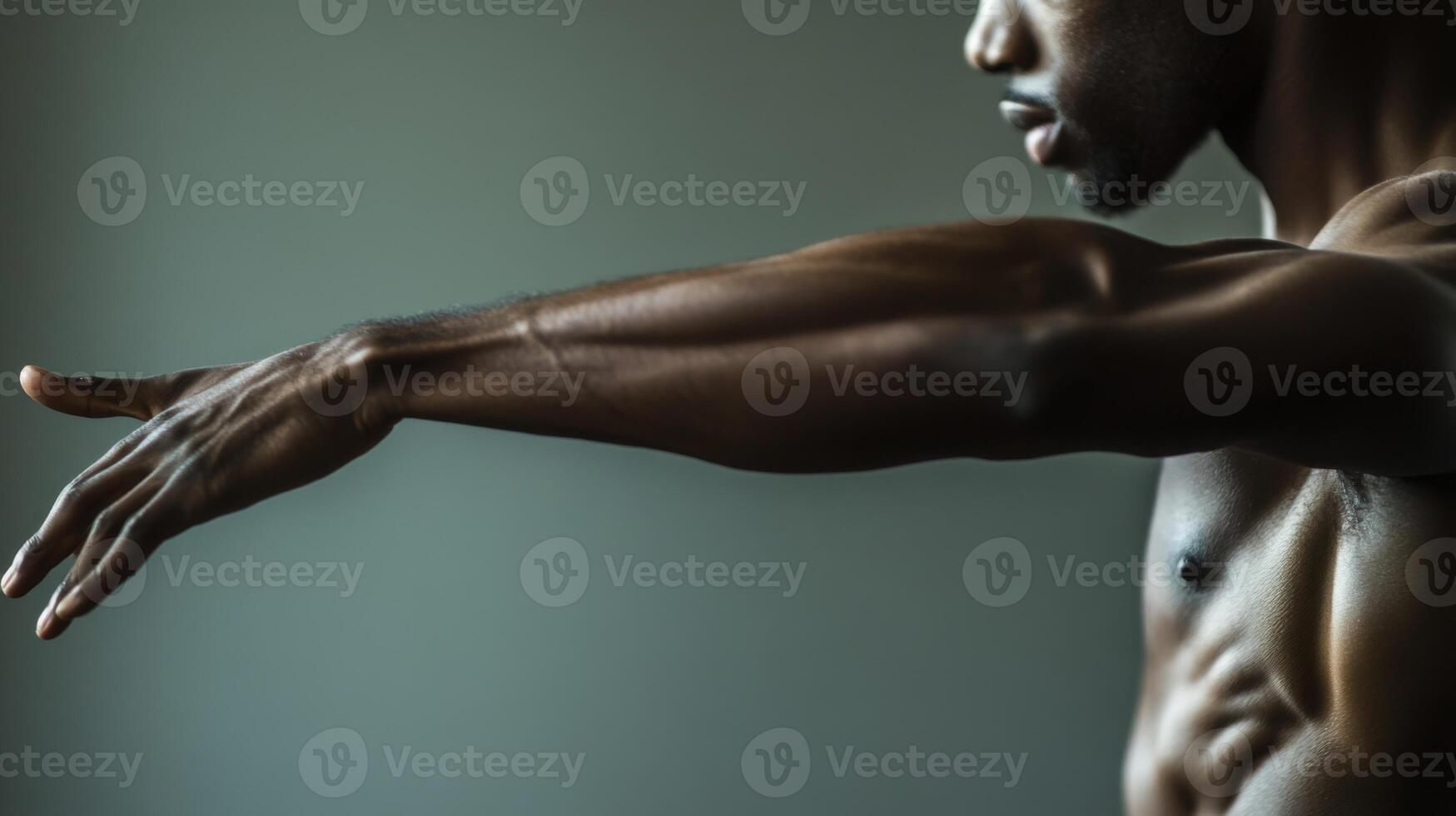 Muscular Man's Arm Extended, Reaching Out, with a Gray Background photo