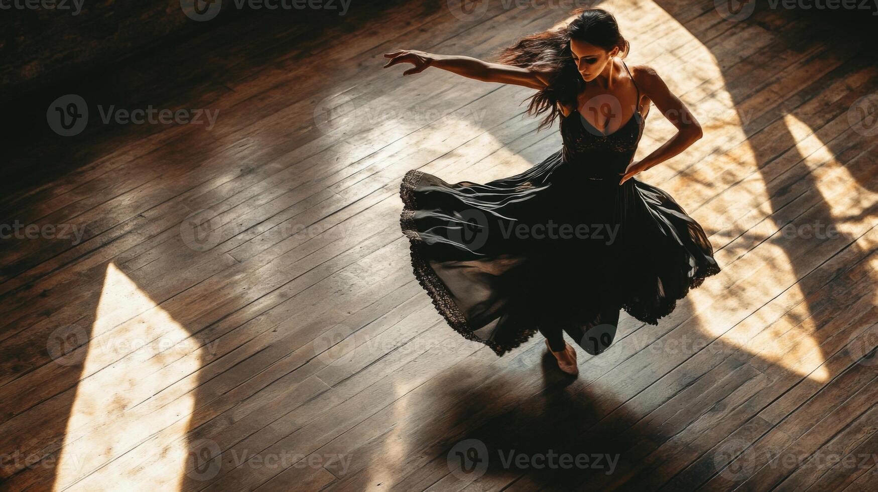 A Woman in a Black Dress Spins on a Wooden Floor photo