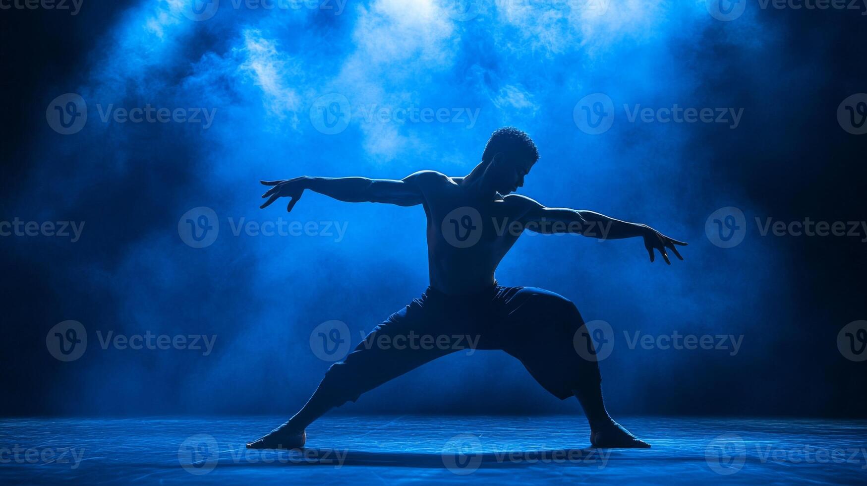 Silhouetted Male Dancer Posing in Blue Smoke photo