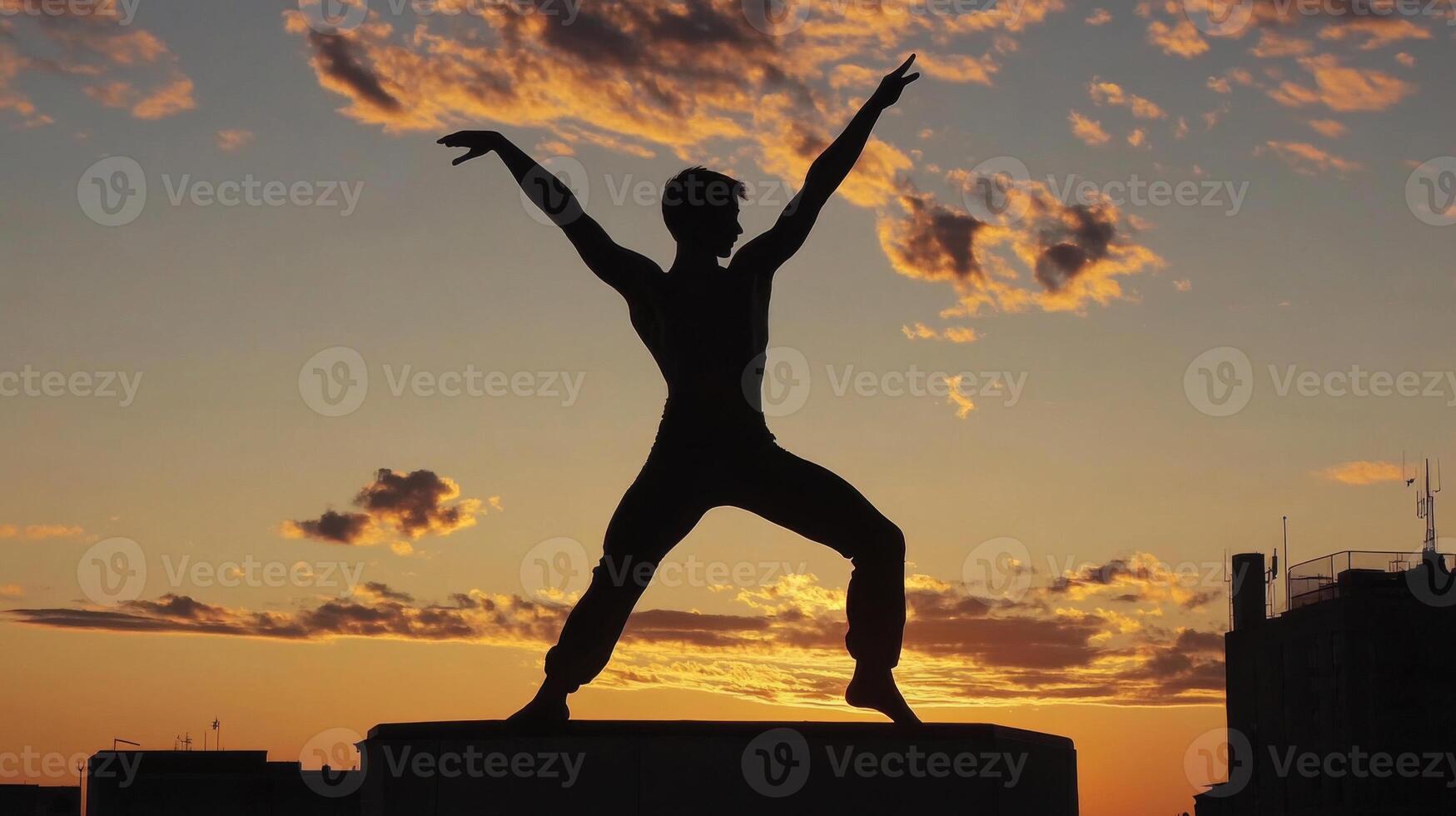 Silhouette of a Man Performing a Dance Pose at Sunset photo