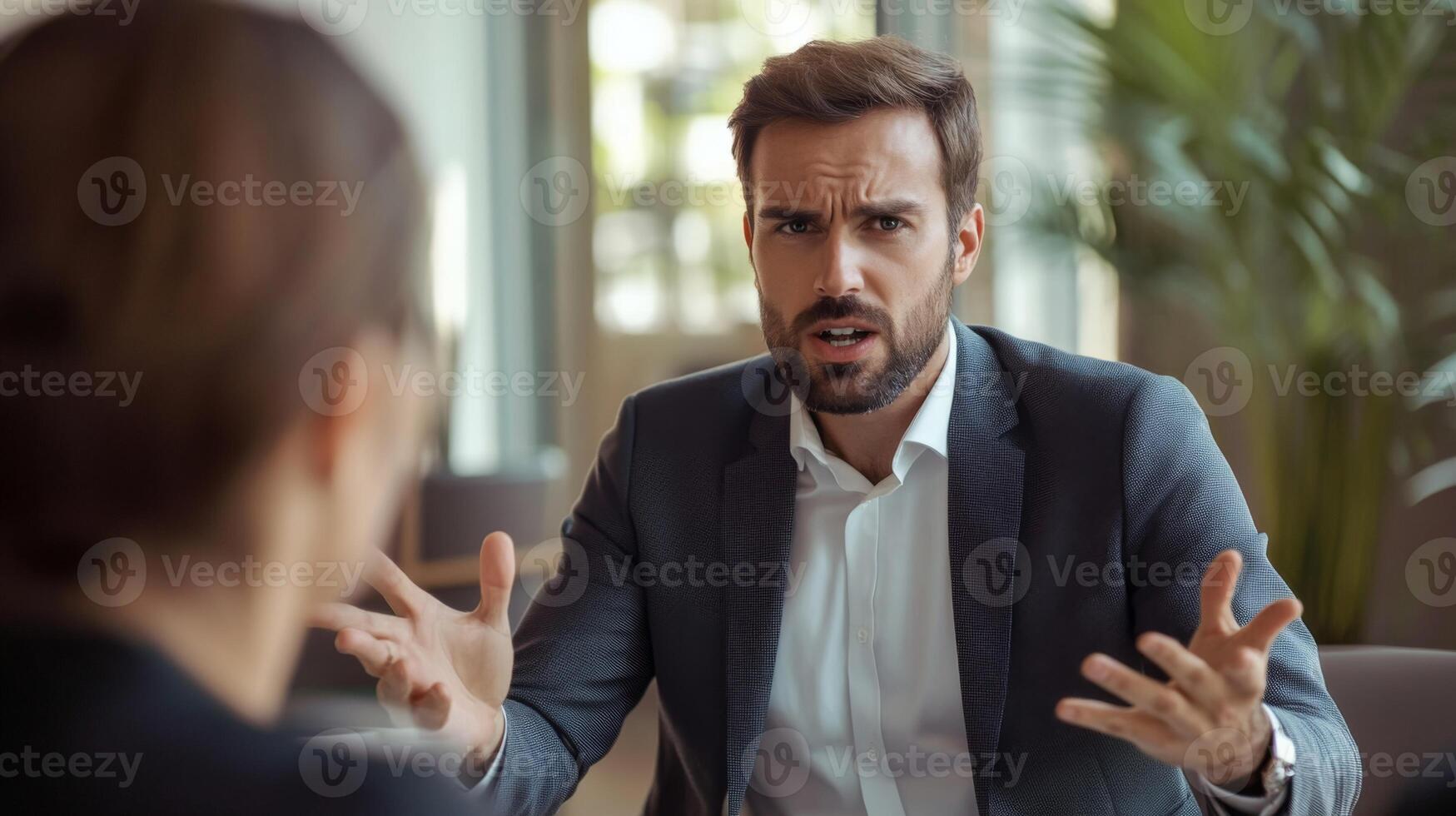 A Businessman with a Bearded Face Gesturing Animatedly While Arguing or Explaining photo