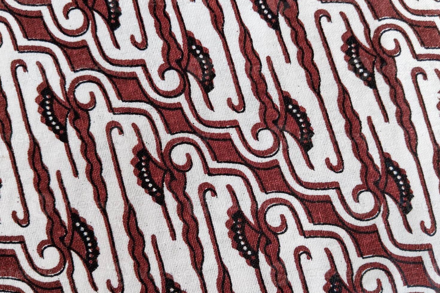 A close up of a red and white patterned fabric photo