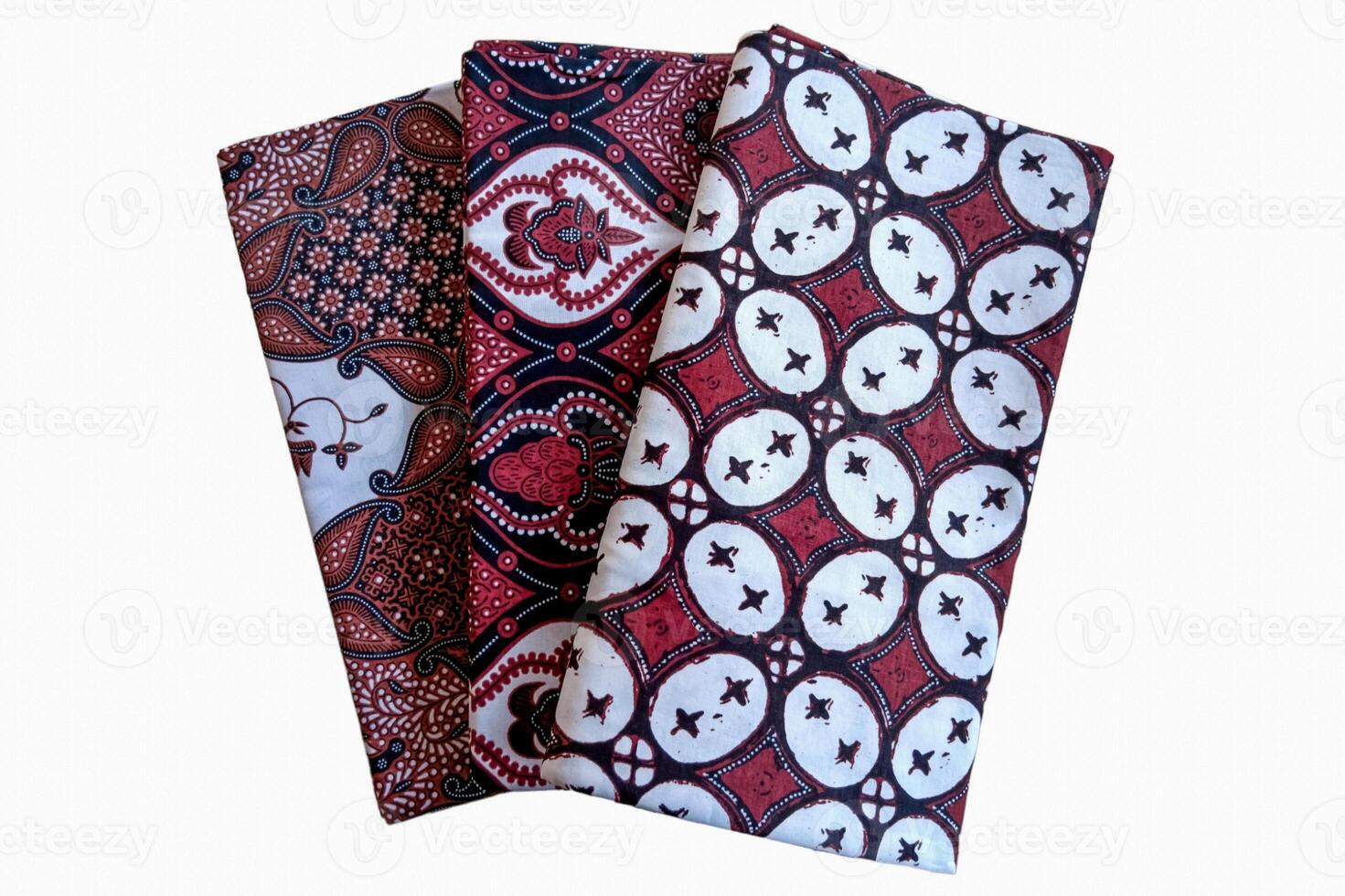 Three red and black napkins with designs on them photo