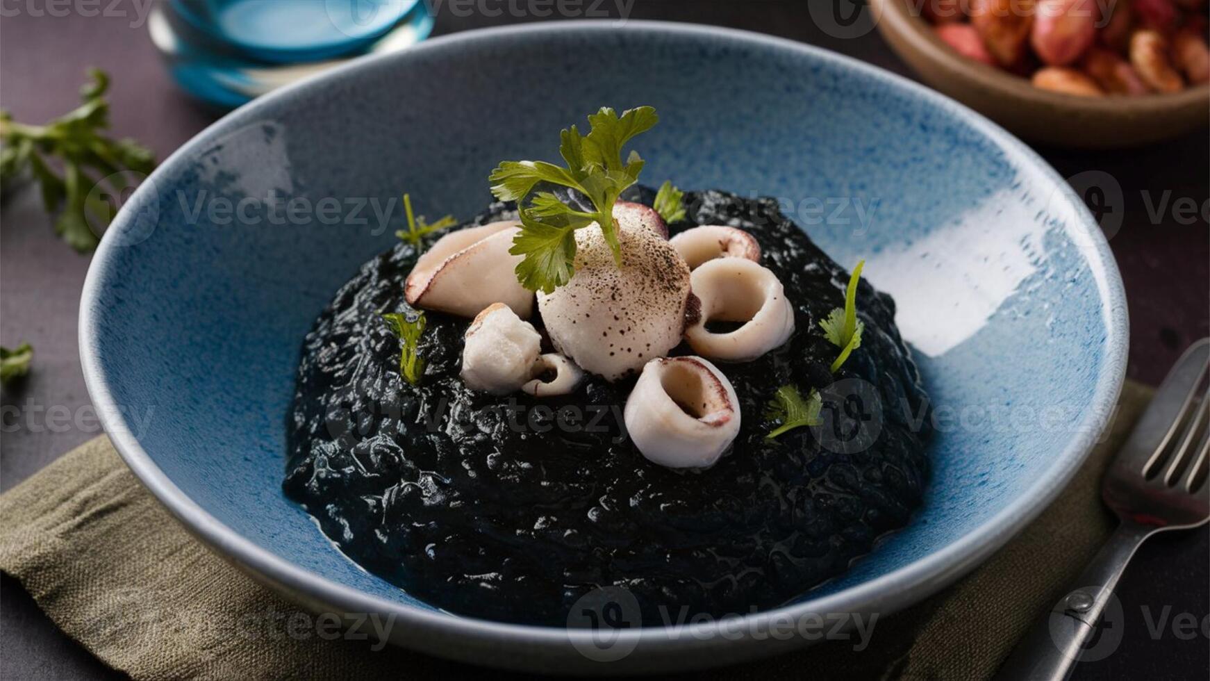 Risotto al Nero di Seppia A strikingly dark risotto made with squid ink, giving it a unique, briny flavor and rich, creamy texture. Often served with pieces of tender squid. photo