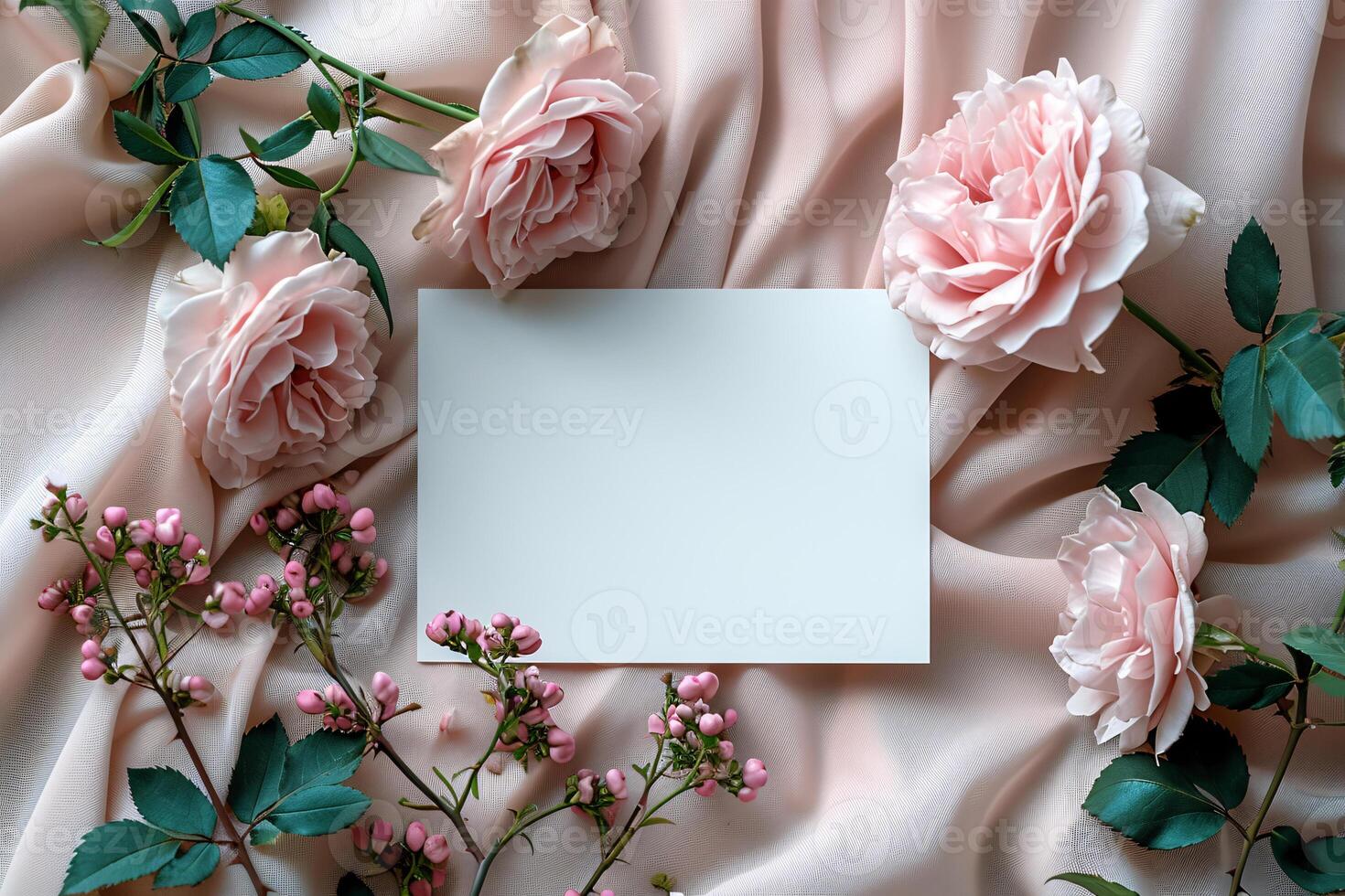A blank card is surrounded by pink roses photo