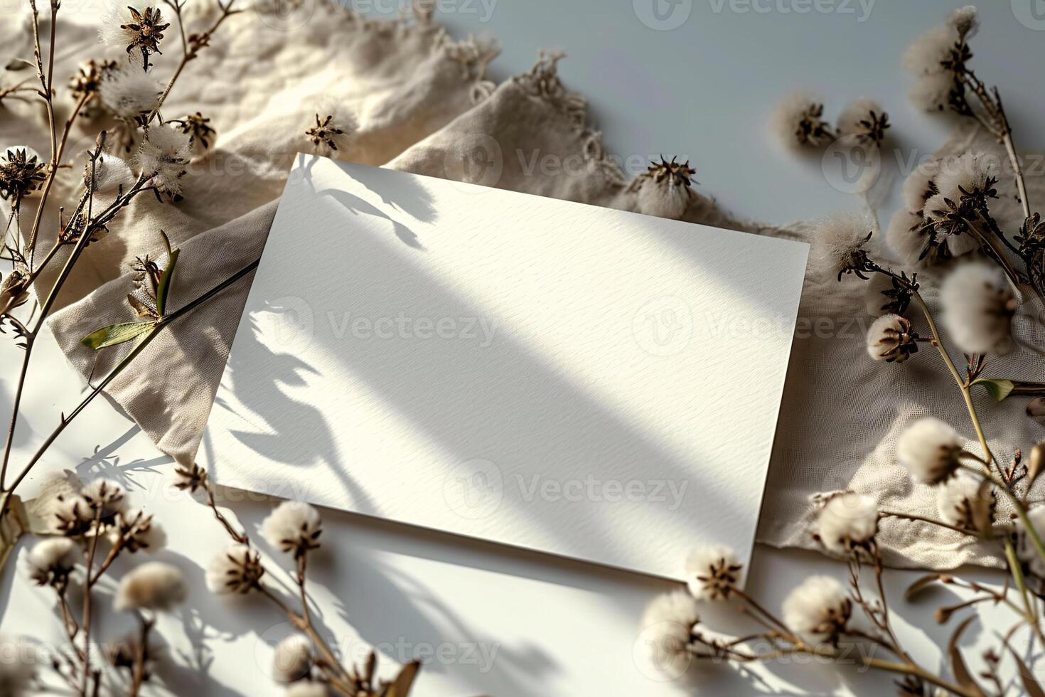 Blank paper on a white table with cotton flowers photo
