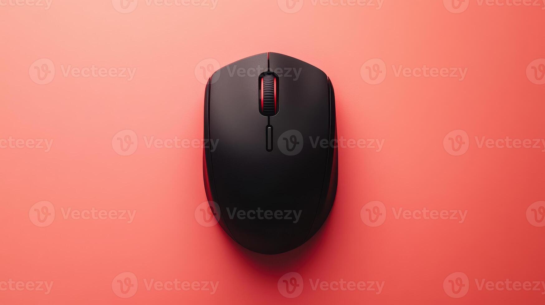 A black computer mouse on a pink surface photo