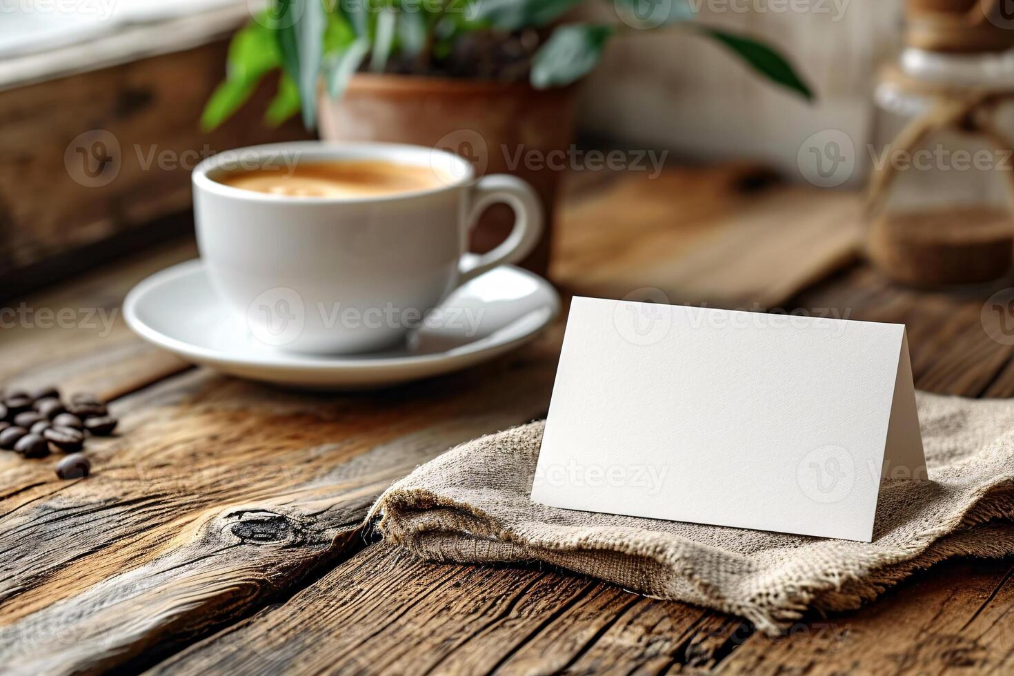 A blank card on a wooden table with coffee beans and a cup of coffee photo