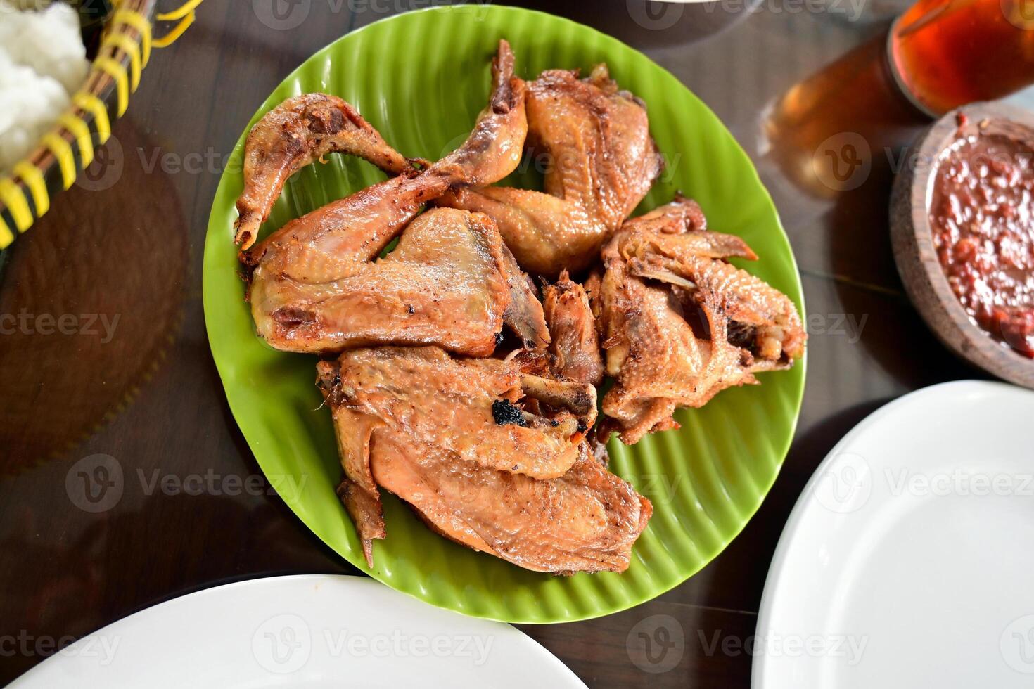 Fried chicken of Kalasan is a fried chicken dish with special spices originating from the Kalasan area, Sleman Yogyakarta, eaten with chili sauce and fresh vegetables. photo