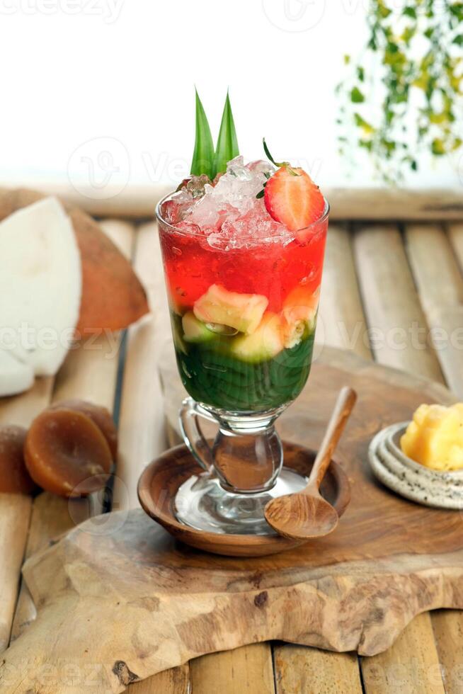 Es Dawet Tape is a traditional beverage from Java, Indonesia, known for its refreshing and sweet taste. The drink features rice flour jelly, served in a mix of coconut milk and palm sugar syrup. photo