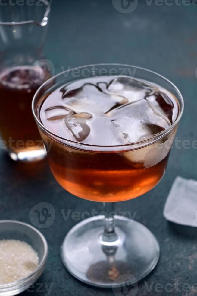 Iced tea with mint leaf under artificial light with shadow, minimalist photography isolated in green background. photo