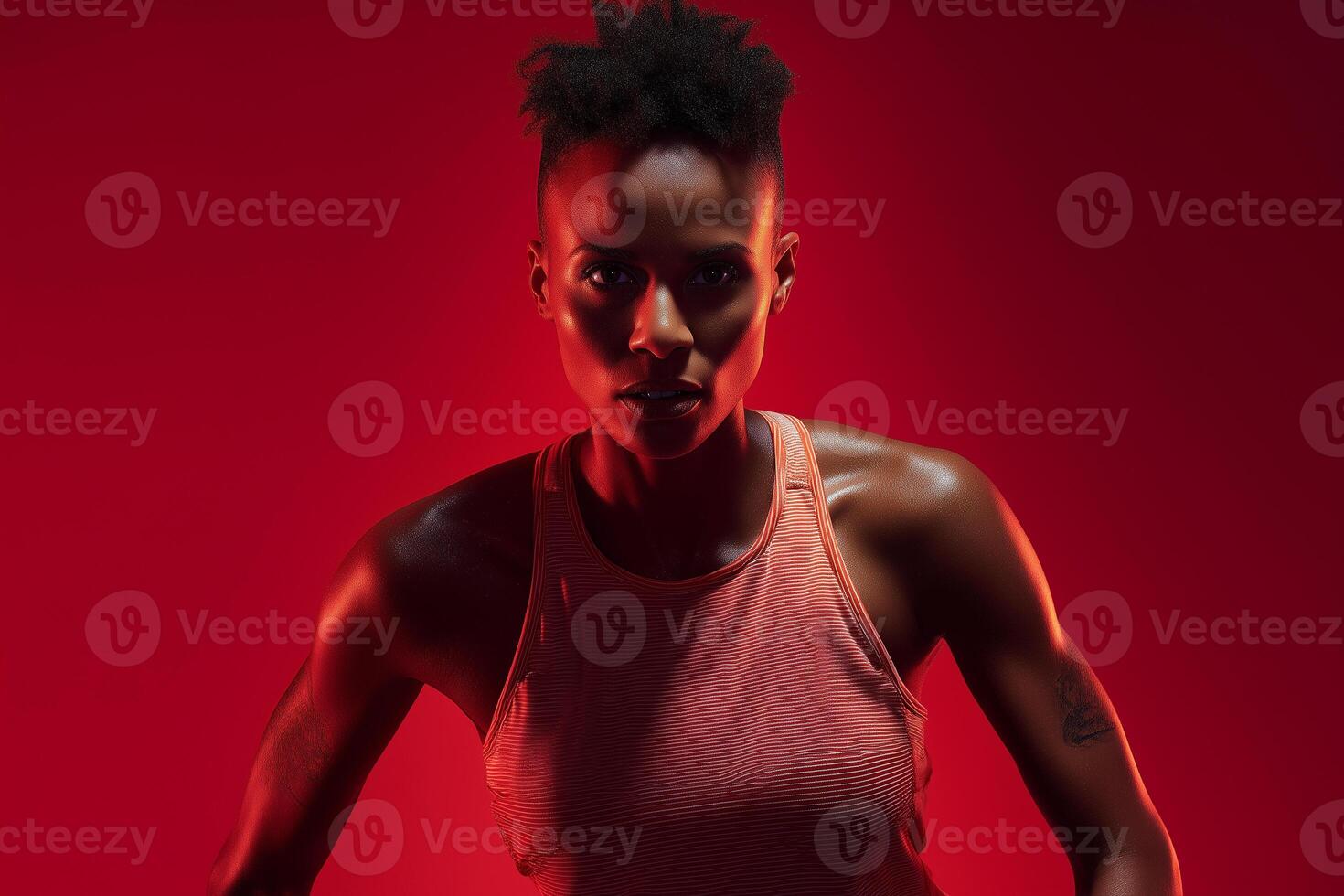 Energetic female athlete focused on running with a determined expression against a vibrant scarlet backdrop photo