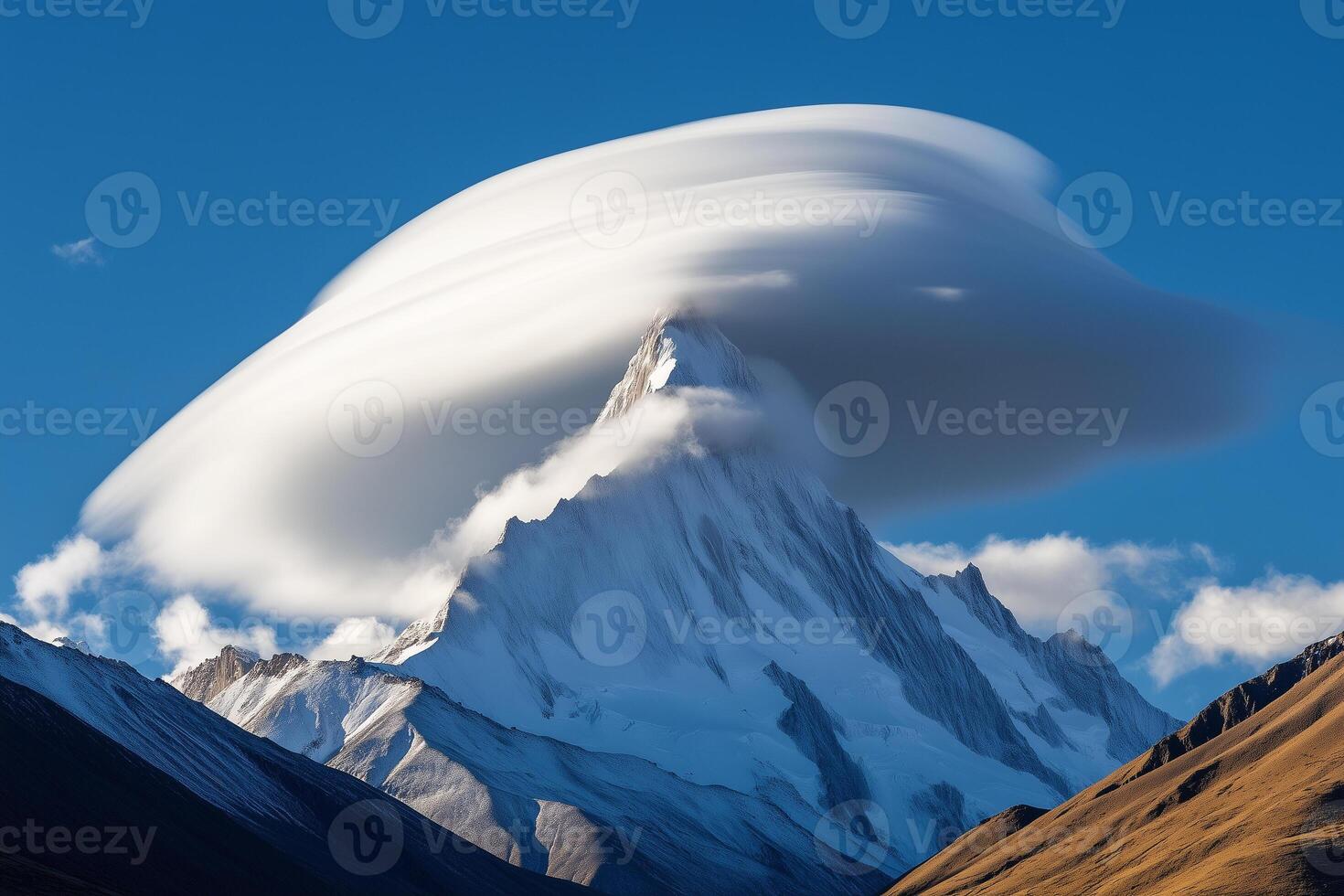 Lenticular cloud formation over mountain peak creates stunning natural display in clear sky photo