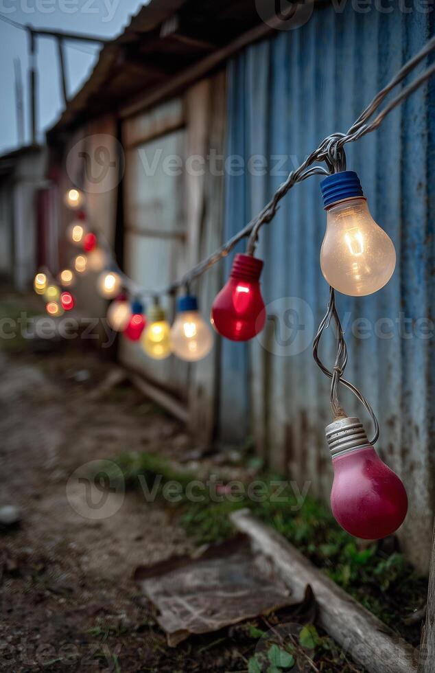 Colorful string lights illuminate an old barn at night creating a festive atmosphere photo