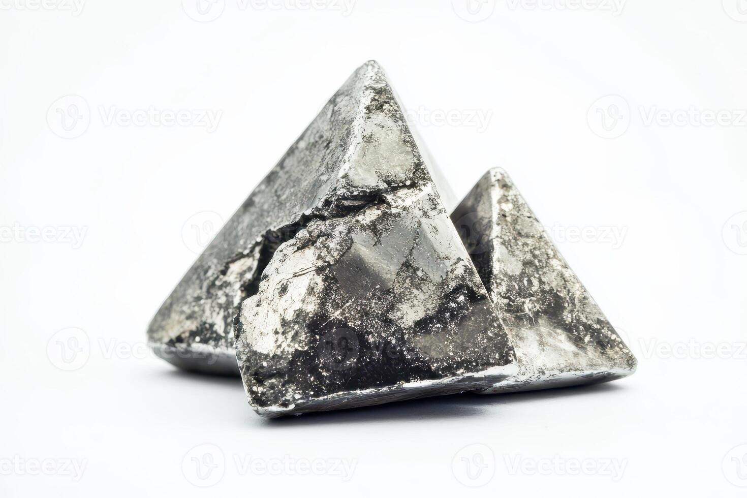 Triangular metal sculptures on white photo