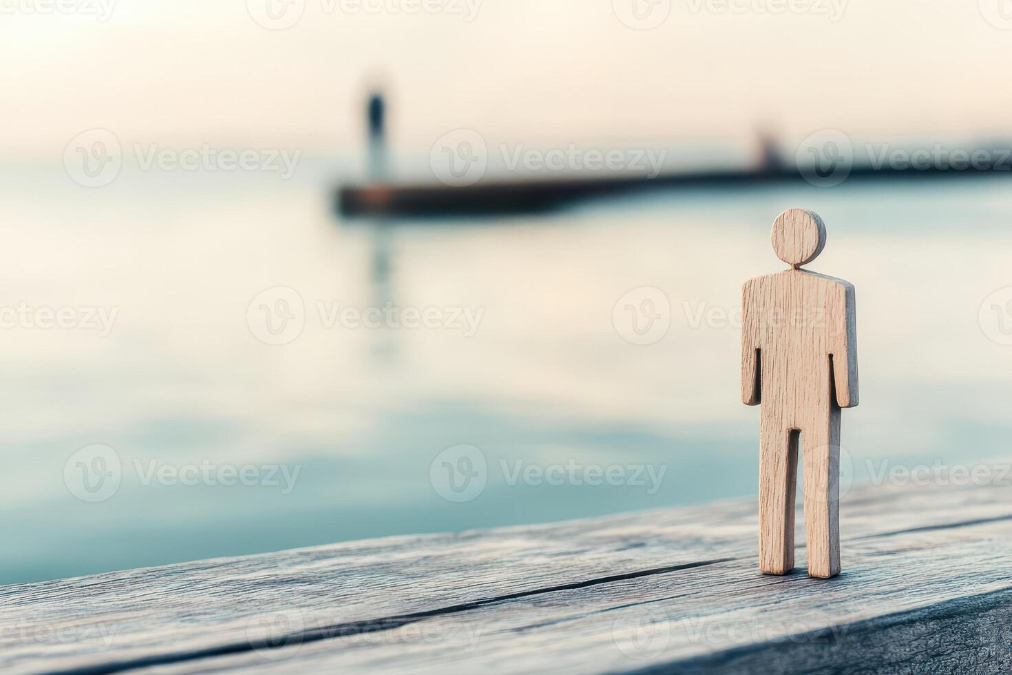 Wooden figure by serene sunset waters photo