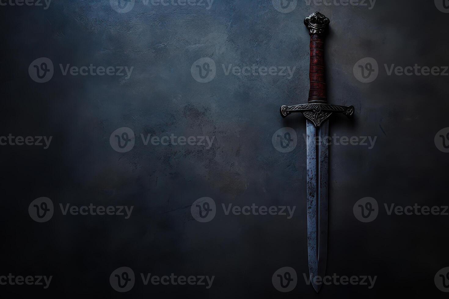 Ornate sword on a dark background photo