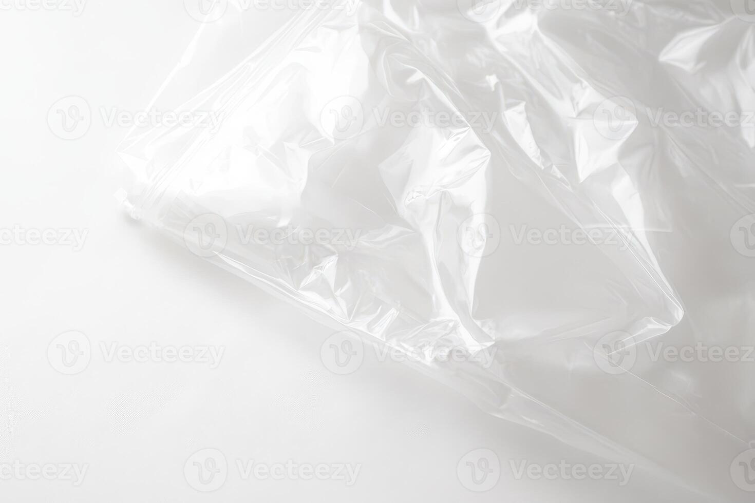 Clear plastic wrap drapes over a clean surface photo