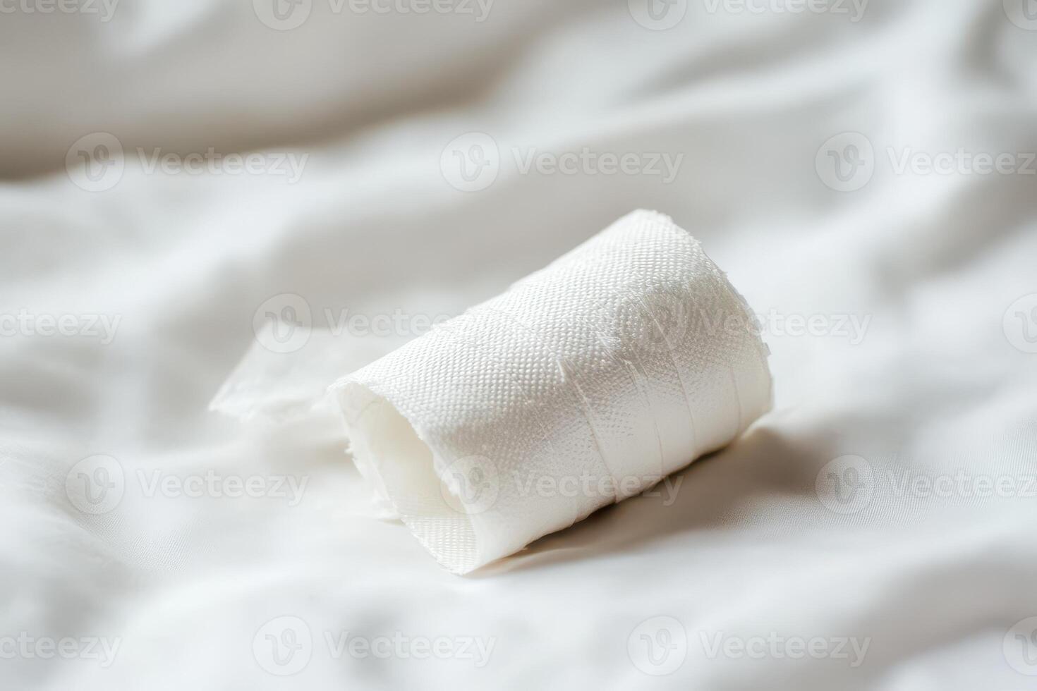 Bandage roll resting on a soft surface photo