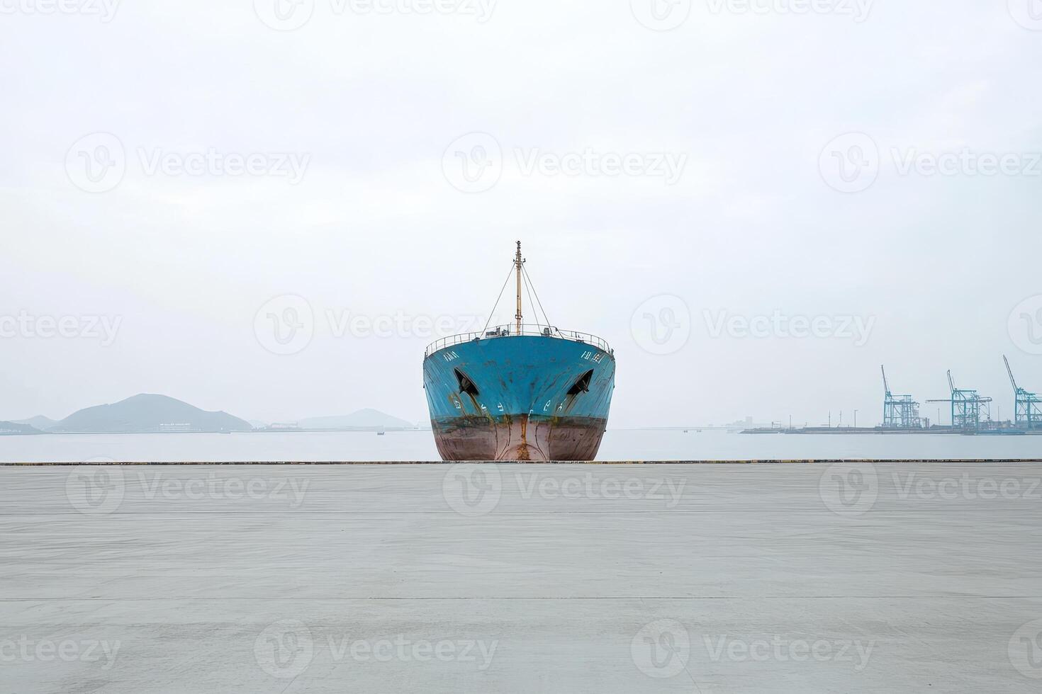 Ship docked at a quiet harbor on an overcast day photo