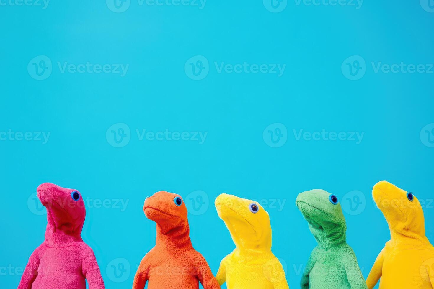 Colorful dinosaur plush toys on blue backdrop photo