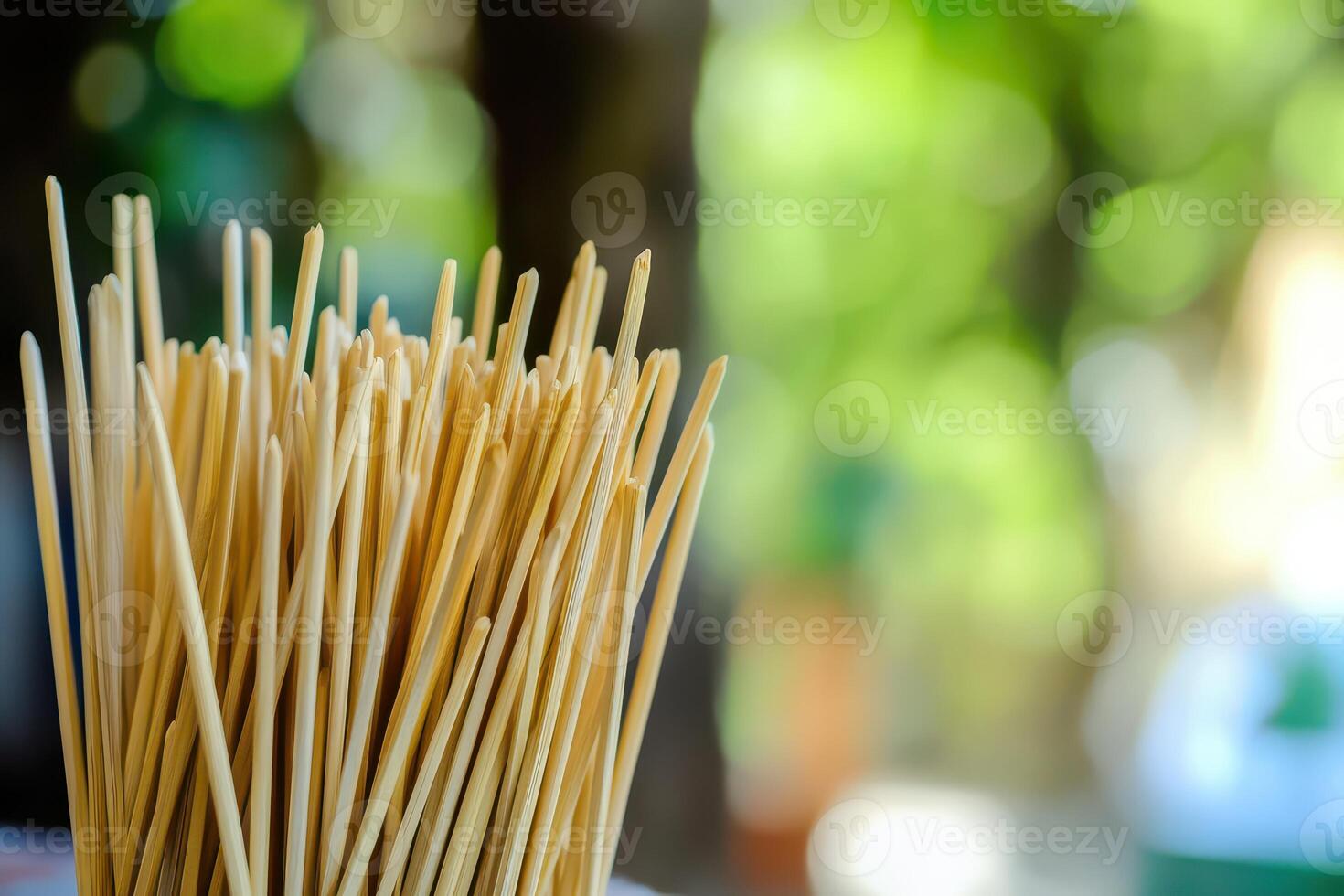 Wooden skewers arranged in a bundle outdoors photo