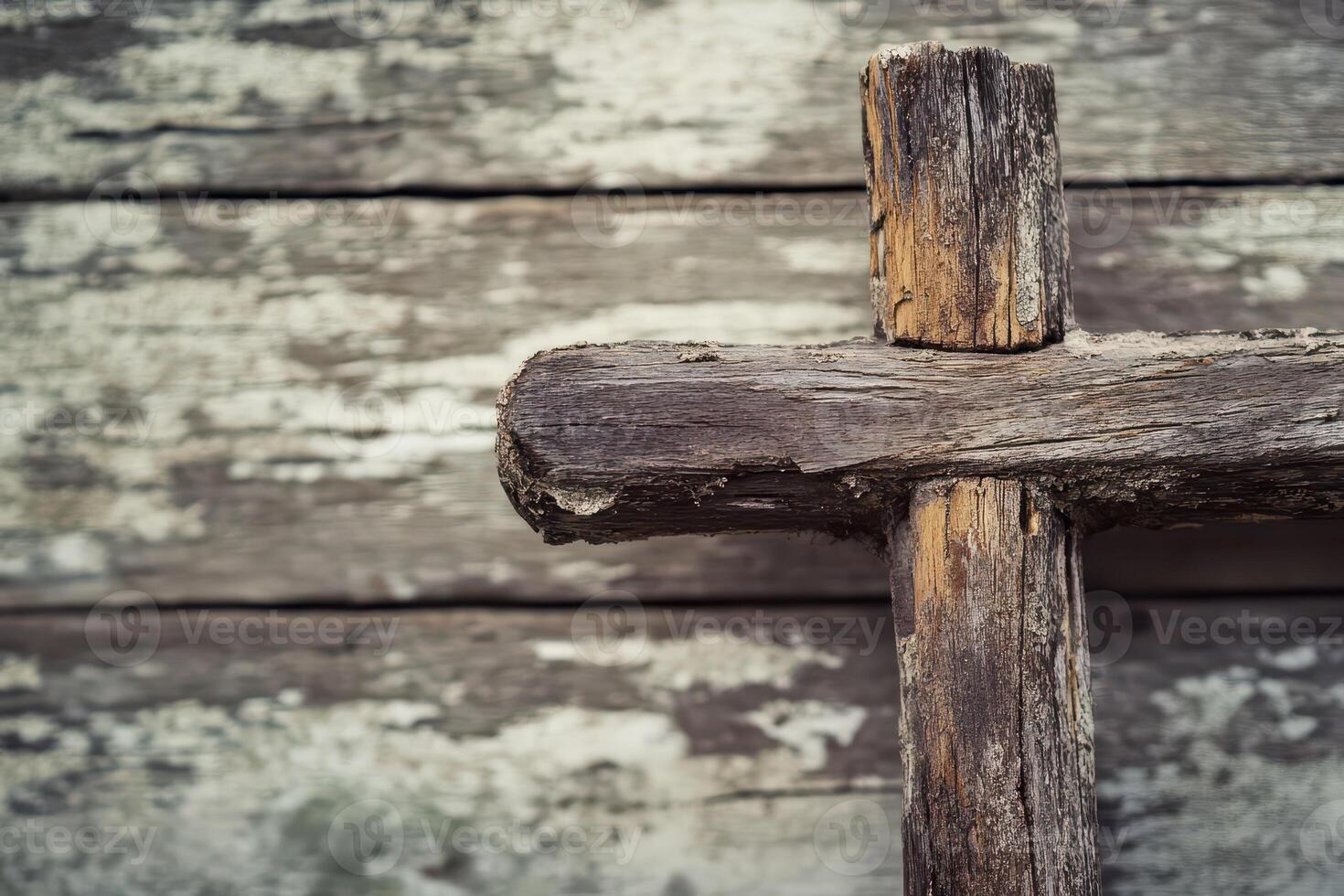 Rustic wooden cross against weathered background photo