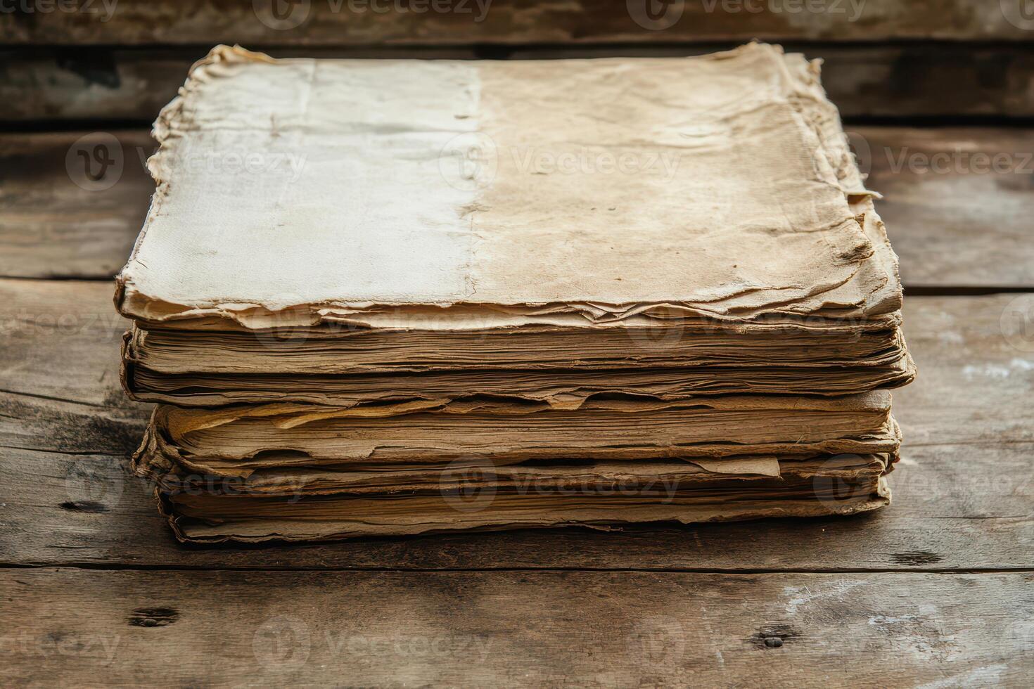 Stacked old papers resting on a wooden surface photo