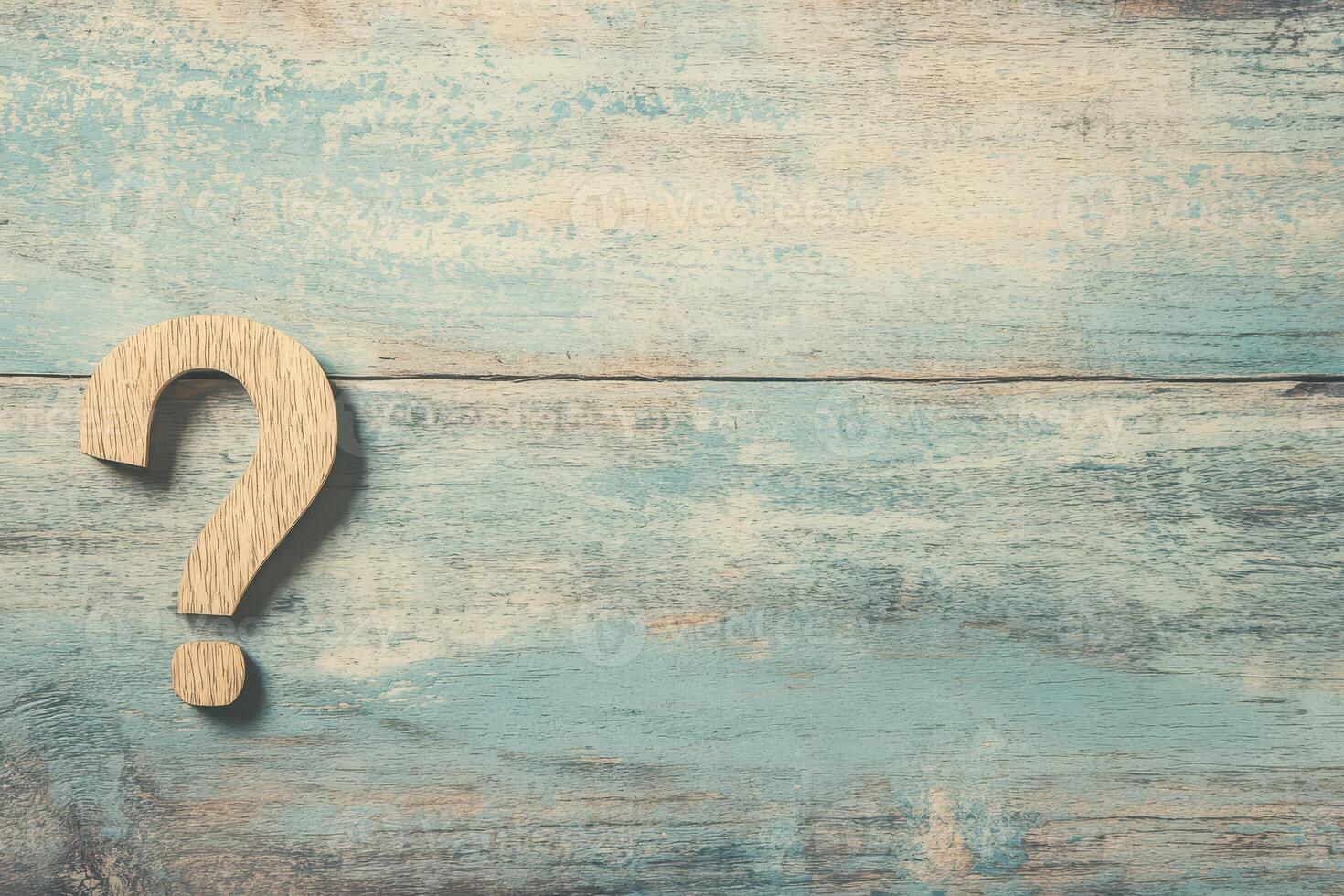 Wooden question mark on rustic blue background photo