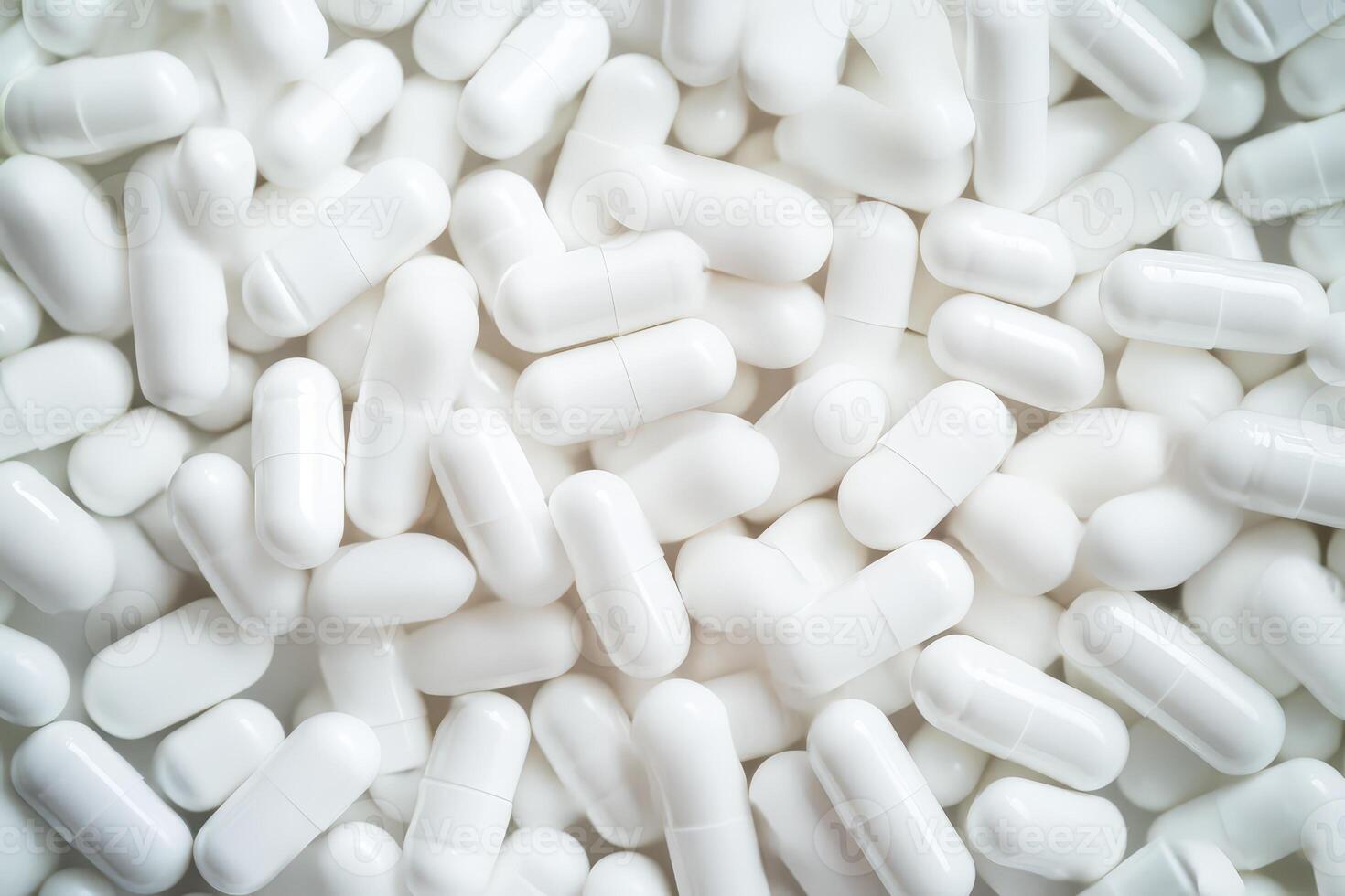 Variety of white capsules laid out on a surface photo