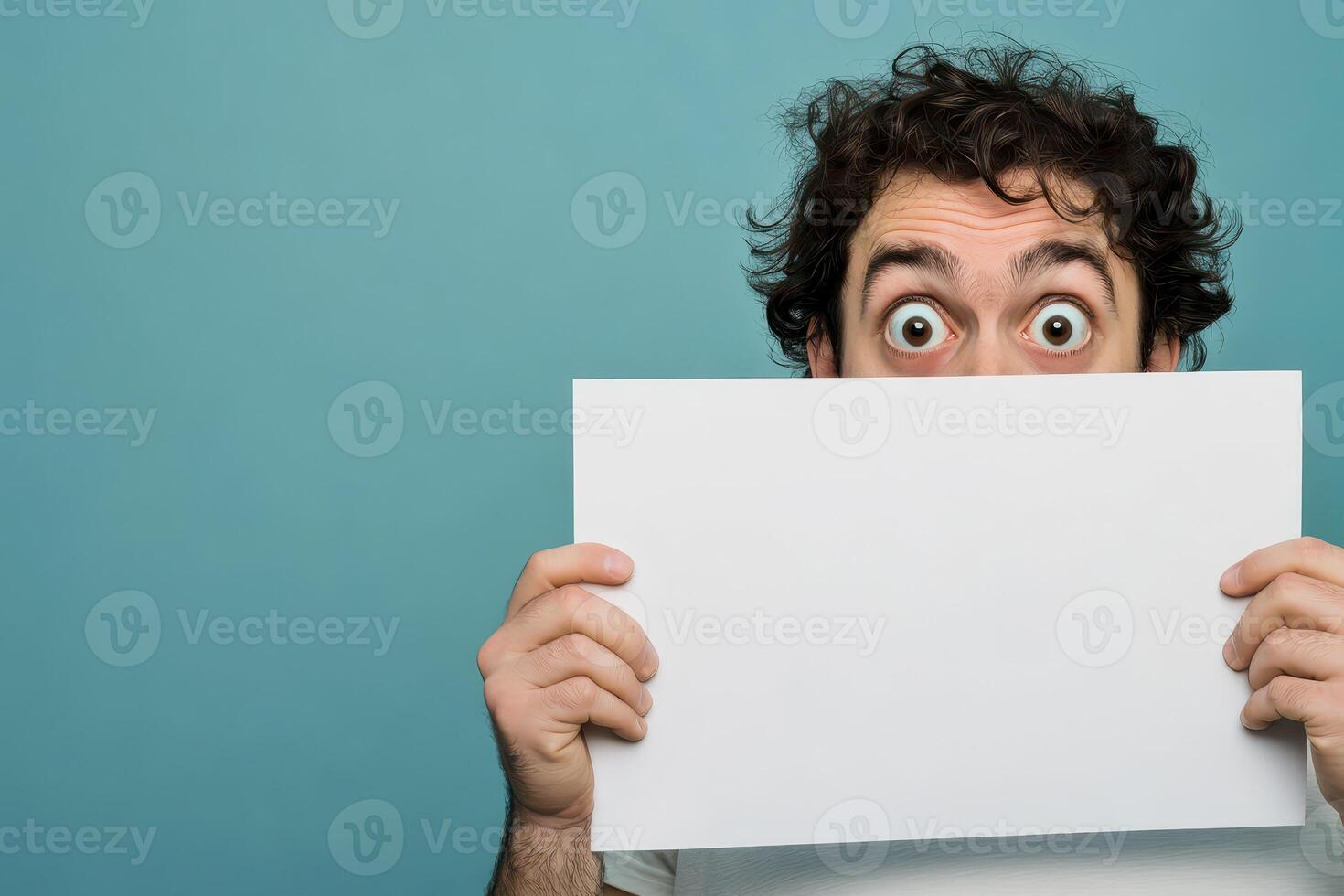 Surprised man with paper in playful pose photo
