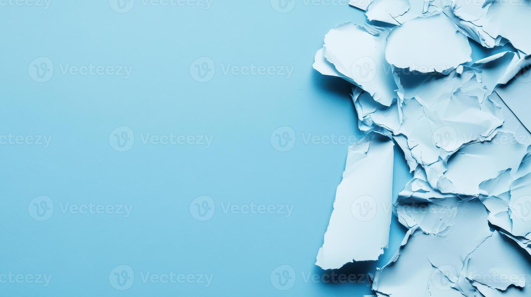 Torn light blue paper texture on solid background photo