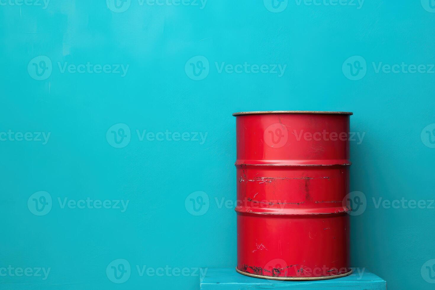 Bright red barrel against a turquoise wall photo