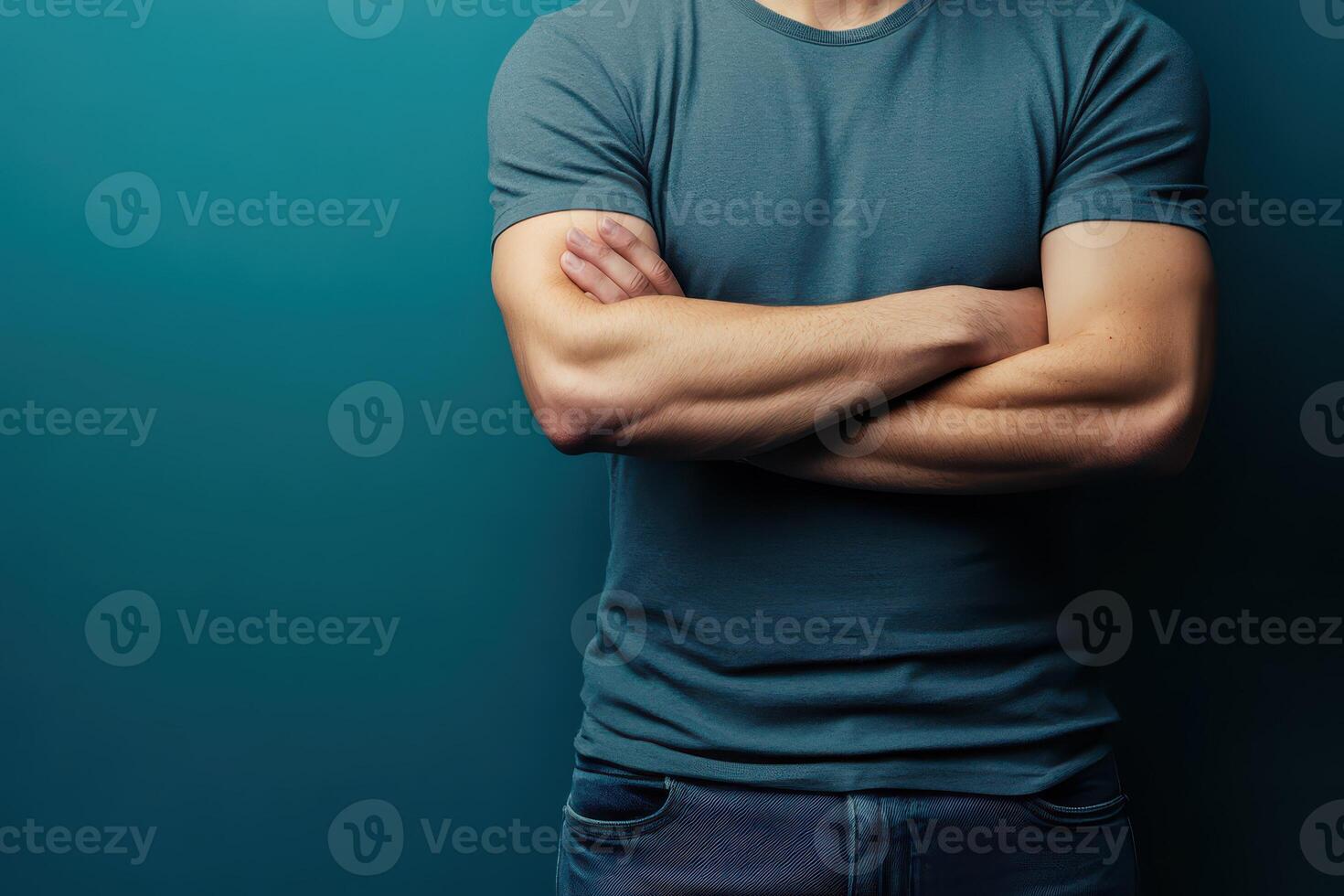 Man with crossed arms against a solid background photo
