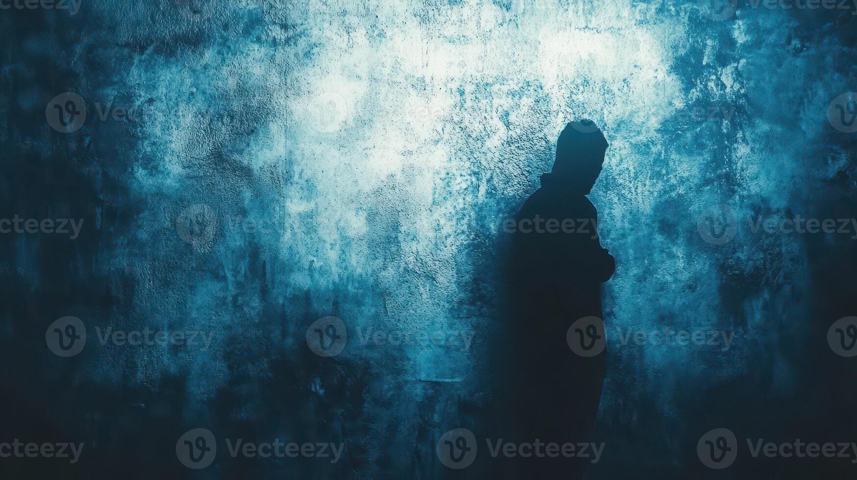 Person standing against a textured blue wall photo