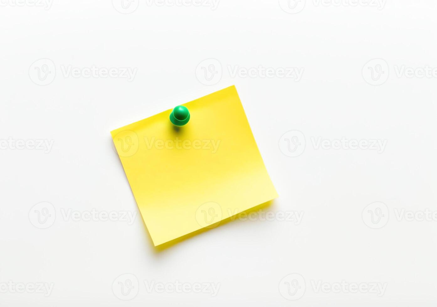 Yellow sticky note with green push pin isolated on white background in high definition photo