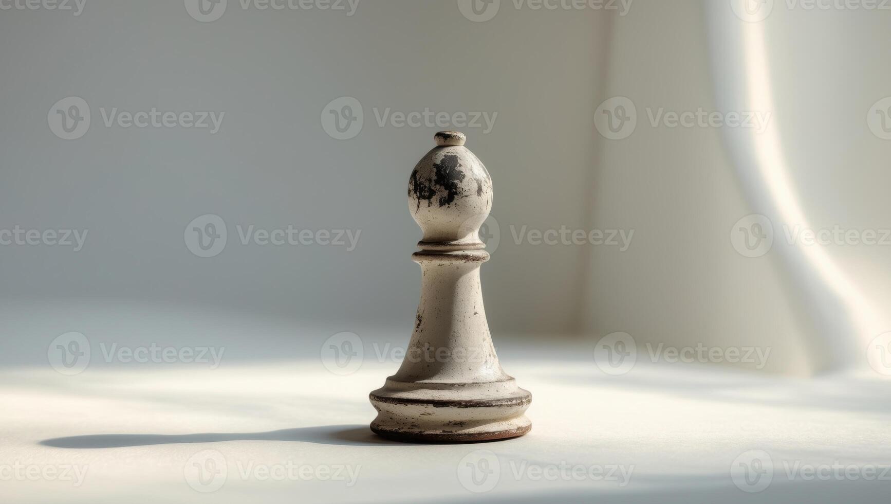 A white chess piece sitting on a table photo